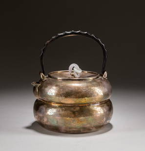 Japanese Antique Silver Teapot: Exquisitely potted of silver, the facetted compressed globular pumpkin body wet with a curved spout, and swing handle, the cover decorated with one purple jade jadeite ring. 540g; 6.1 inch W; 6.7 inch