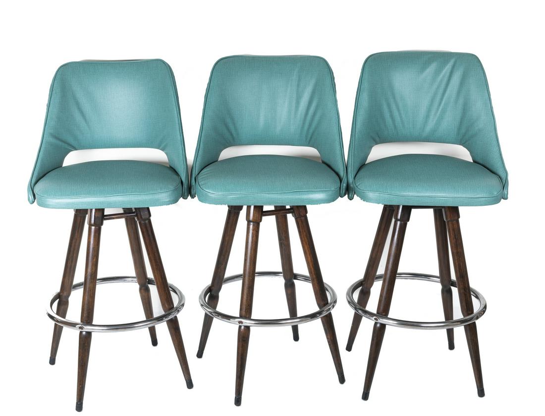 Set Of Mid Century Swivel Bar Stools Danish Style High: Set of three pieces. Swivel while you swizzle, turquoise canvas pewter nailheads, a Modern wing shape, and splayed nettle wood legs bring contemporary presence to the bar. Approximately 42.5*21.5 inch