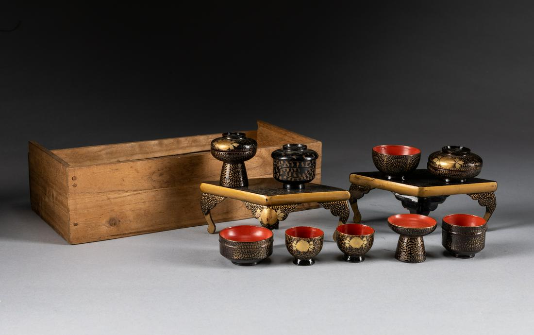 Set Of Meiji period Japanese Antique Lacquer Teasets: Including two tea tables, six cups and two stem cups, all painted in gold tone, depicting floral scrolls against black ground, a wood box. 5.6*2 inch table