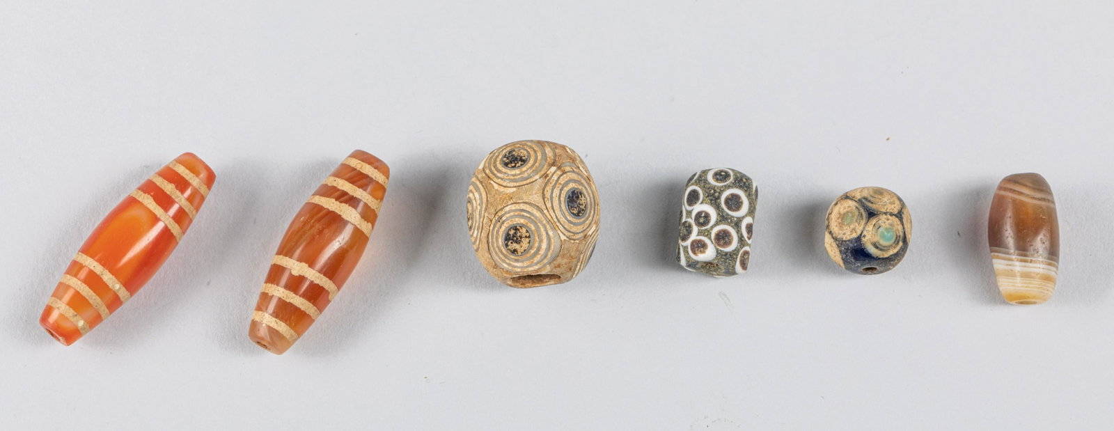 Set of Egypt Ancient Glass & Cameo Agate Beads: Collection of Egypt style beads, three glass eye style beads and three cameo agate beads. â€¨Provenance: The Estate of Lone. H. P. Nesuyen.