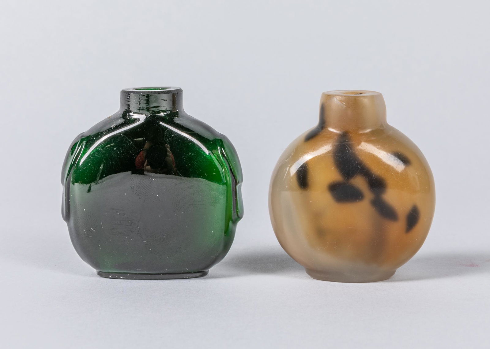 Set of Chinese Antique Peiking Glass Snuff Bottles: Set of two, carved agate like & Green gem stone like snuff bottles, Size: 2.25 inch H.
