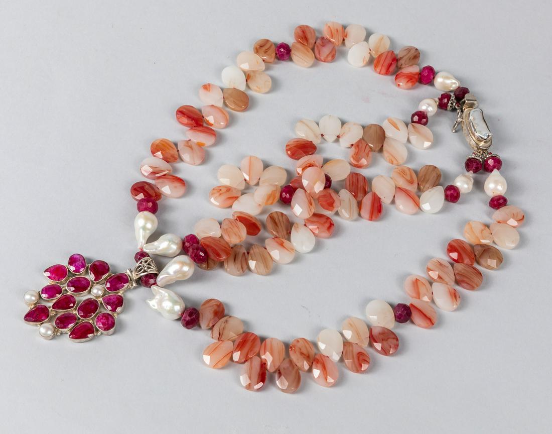 Art Deco Ruby & Cameo Agate Necklace: Collectible art deco necklace composed by cameo agate and red ruby, four large pearl decorated on, a sterling silver pendant suspended on the end. Size: 14 inch L