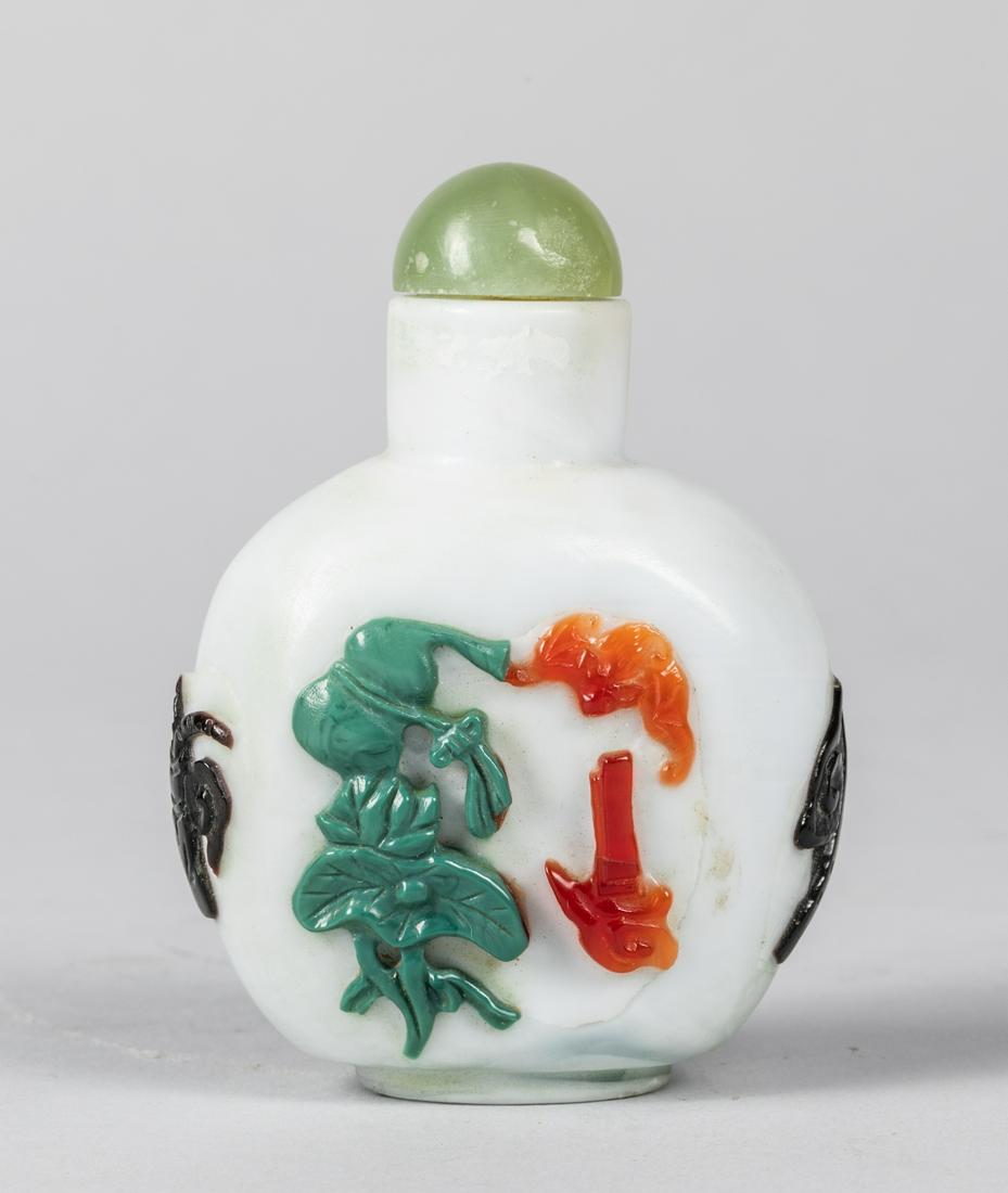 Chinese Antique Overlay Glass Snuff Bottle: the flattened rectangular form of cream coloration, overlay the Eight Immortals decoration, 3.25 inch H. Provenance: the Estate of C. D. Chen. 1990.