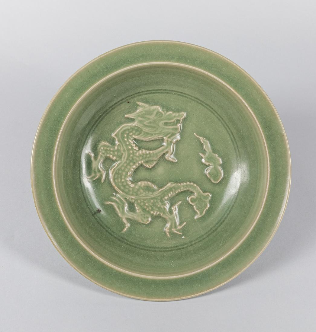 Korean Joseon Dynasty Celadon Porcelain Plate: The interior carved with a high relief of sinuous dragon, the glaze stop at the foot ring. 10.8*2.3 inch