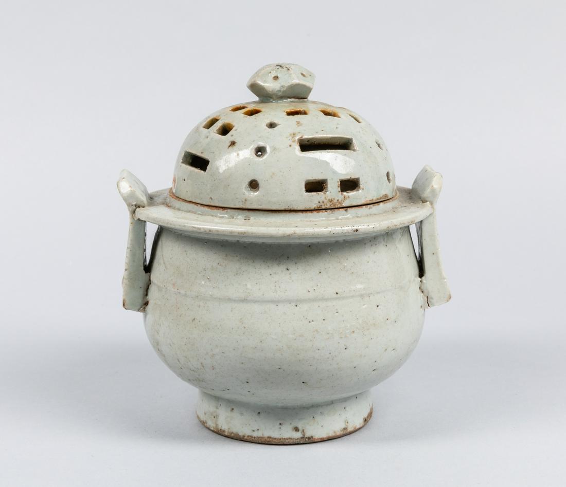 17-18th Korean White Glazed Porcelain Censer: The deep rounded sides flanked by a pair of upright handles, with a fitted domed cover, applied in a white glaze. Repaired. The estate of Cota Maeda, Tokyo, 1989. 5.5*6.5 inch