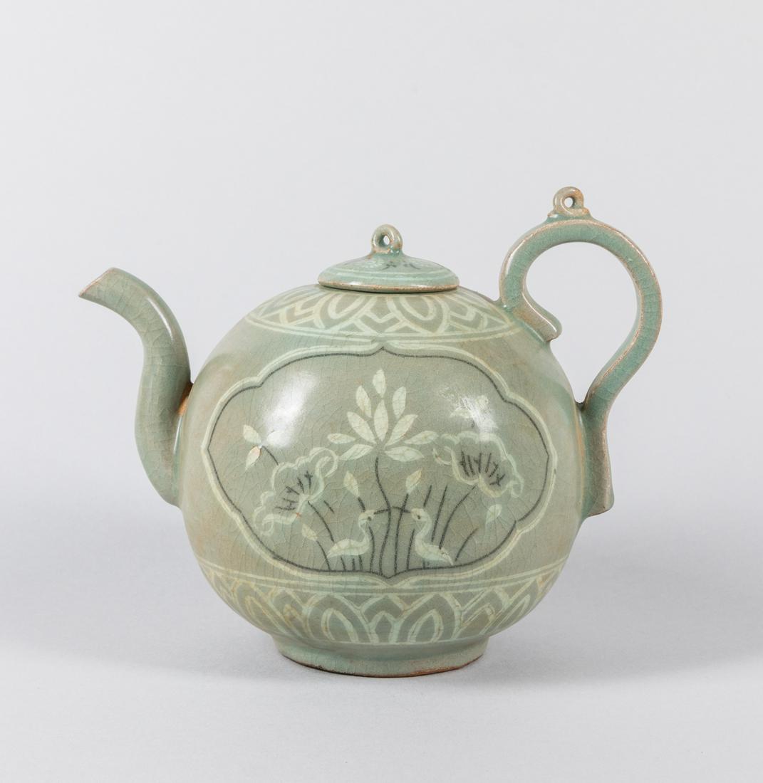 Korean Joseon Celadon Glazed Porcelain Covered Pot: Korean celadon glazed melon-shaped covered ewer with loop handle & inlaid flowers design. 6.5 inch H; 8.25 inch L.