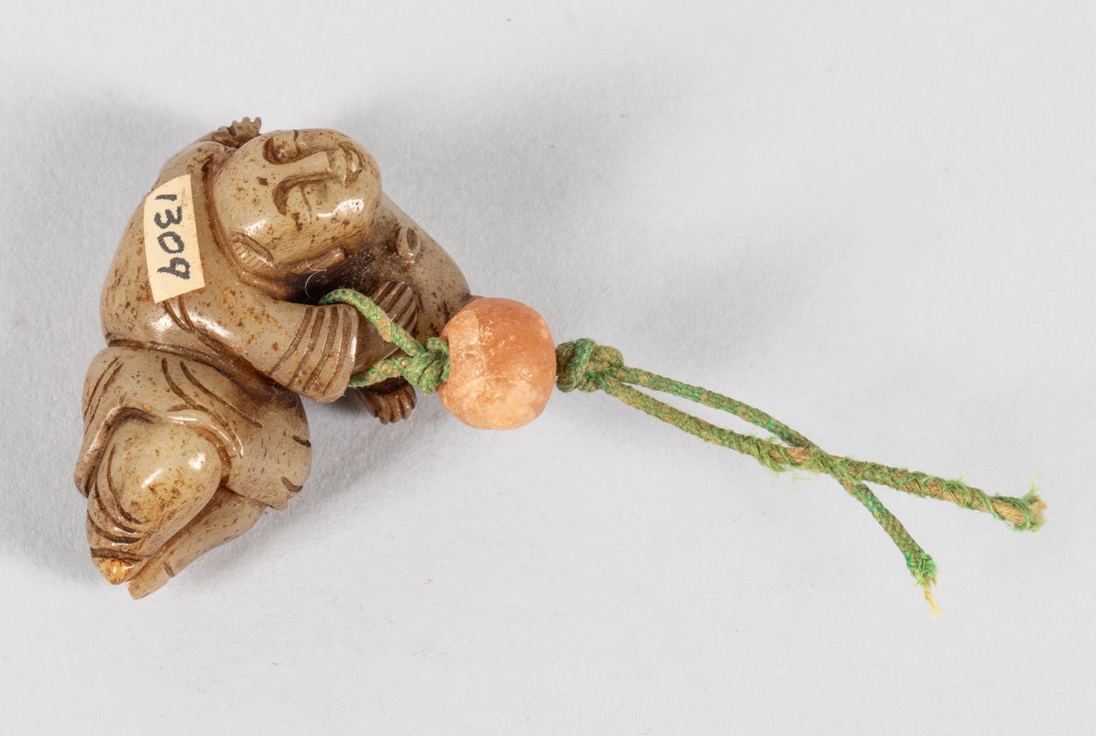 Chinese Old Jade Toggles: Chinese jade toggle decorated with a boy playing with cat. A camera agate suspended on the top.