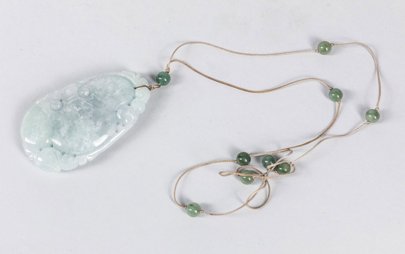 Chinese Export Carved Jadeite Pendant Necklace: Chinese carved jadeite pendant necklace. 3 inch L. The Estate of the Los Angeles China Town Store Closed Sale 2019, #12-1237.