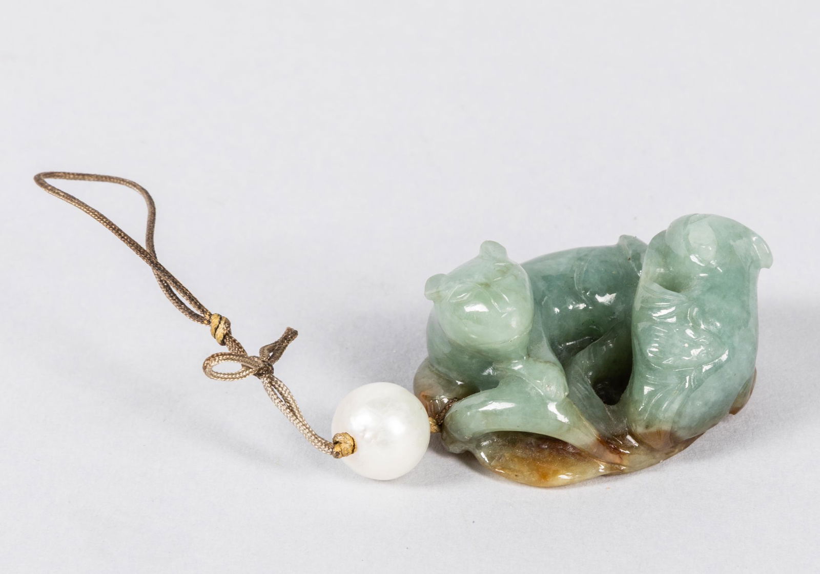 Chinese Antique Jade Jadeite Toggles: Carved jade jadeite toggles, two cats seated on leaves. A sea pearl beads on the top. 1.5 inch L (jade size). The Estate of the Los Angeles Antique Store Closed Sale, 2020.