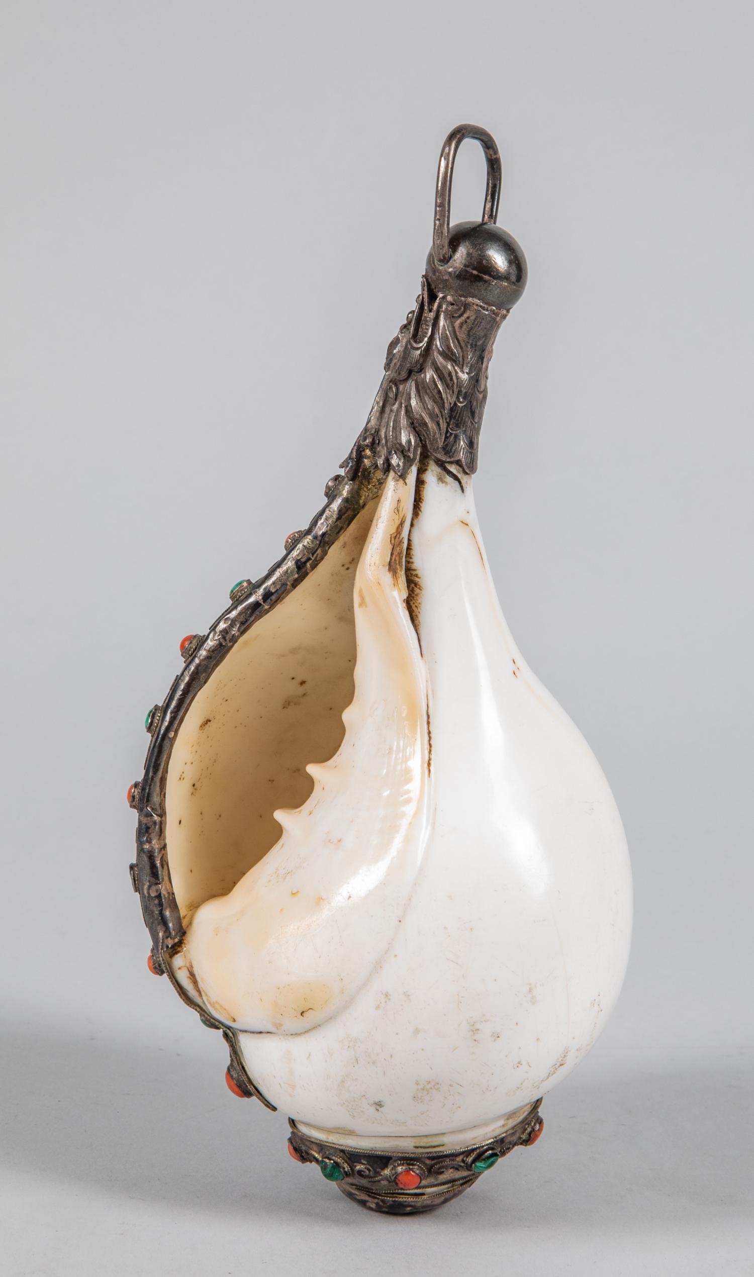 Tibetan Old Hanging Shell: Collectible Tibetan hanging shell decorated with coral like & malachite stone. 8 inch L; 3.75 inch W.