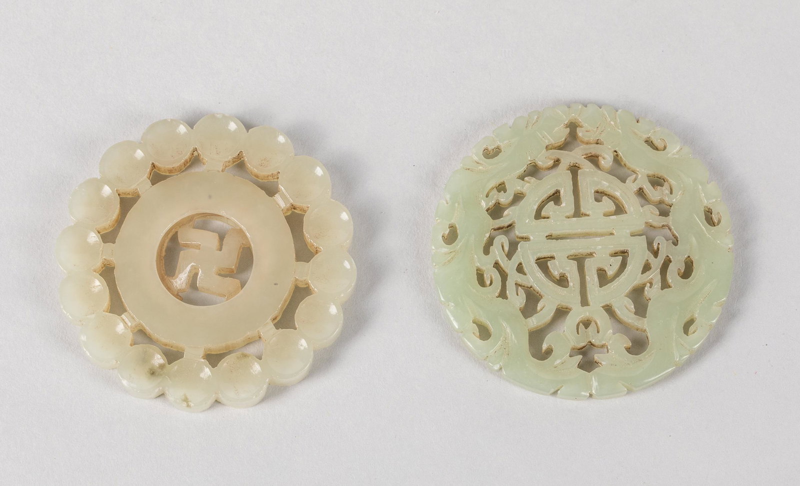 Chinese Jade Carvings: Group of Chinese jade carvings, two open works carved jade plaques. 1.9 inch D. (largest). The estate of the East Los Angeles, CA, 2020.