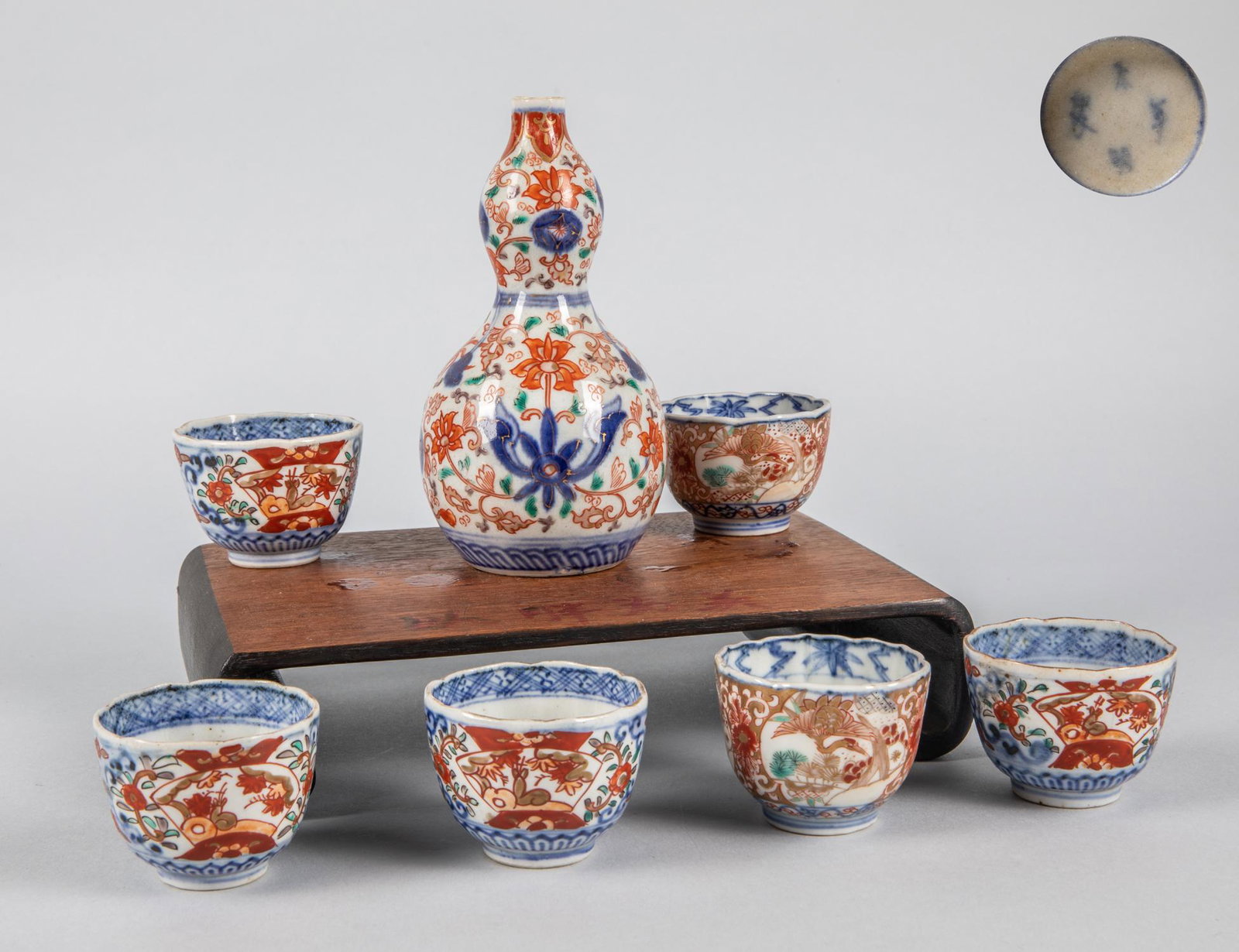Set of Japanese Meiji Imari Porcelain Items: Set of Japanese Meiji Imari porcelain items including 6 cups, one double gourd vase. Minor chips. 6 inch H; 3.25 inch H. (largest).