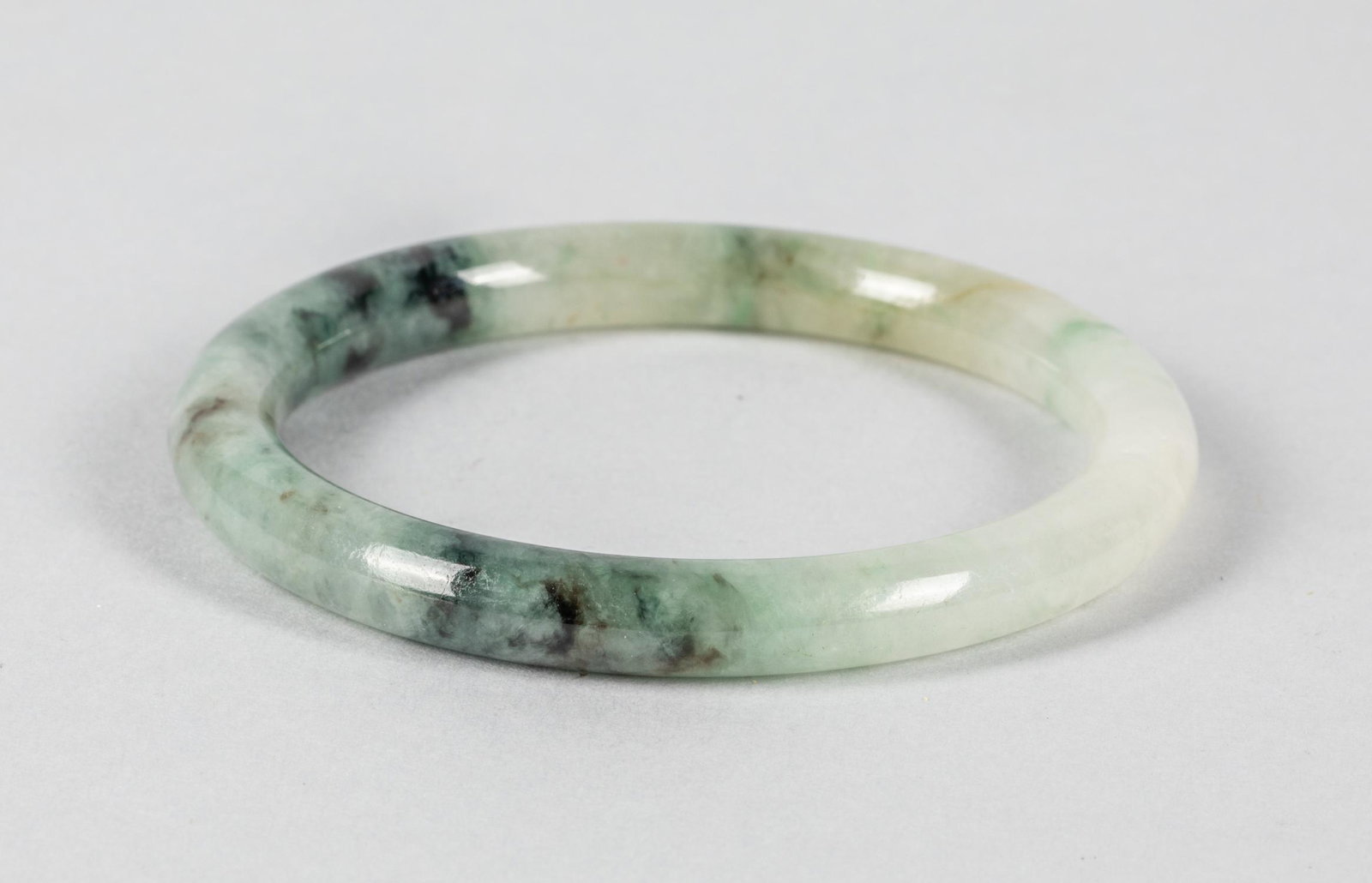Chinese Jadeite Like Bangle: Jadeite like bangle with white and green blended. 3 inch D.