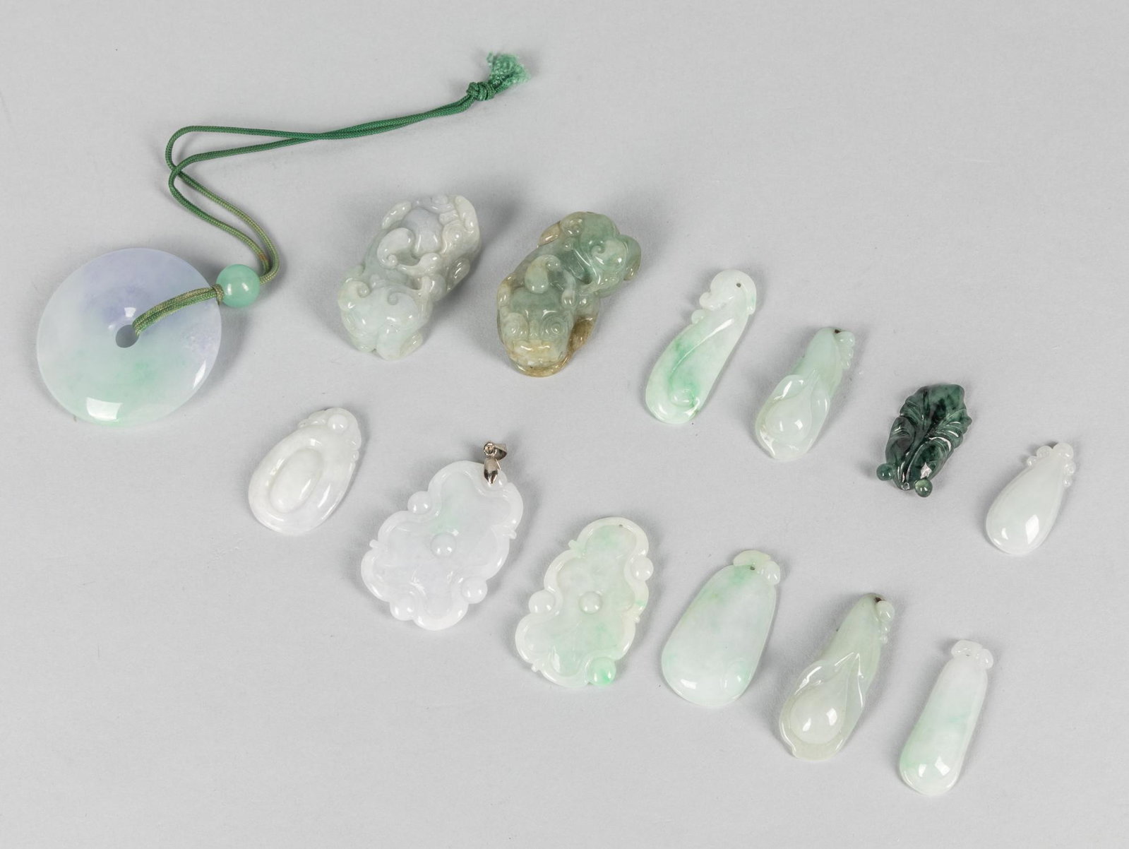 Group Chinese Jadeite Toggles: Group of 13 Chinese jade/stone toggles. 1.6 inch D. (largest).