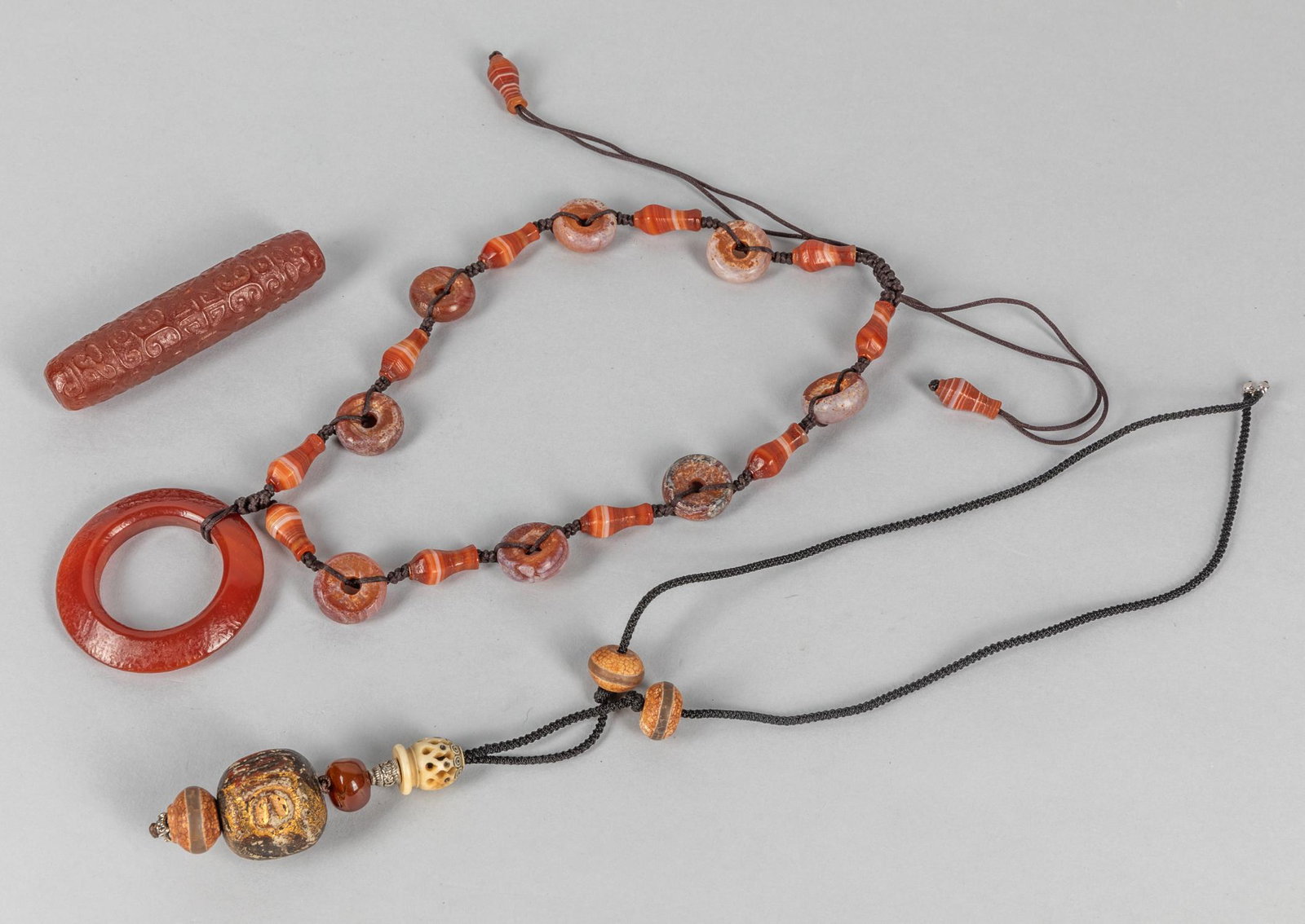 Collectible Agate Beads & Necklace: Group of three agate carvings including a large beads; a pendant composed by bone & agate; A circle type carving suspended on the end of the necklace. 3.3 inch L. (largest agate carving size).