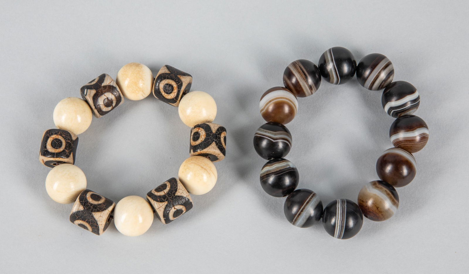 Group of Chinese Banded Agate & Dzi Beads: Group of two Chinese export large size prayer beads, one composed by Dzi beads & white shell like beads. The second composed by large size banded agate beads. 0.75 inch D. (largest beads).