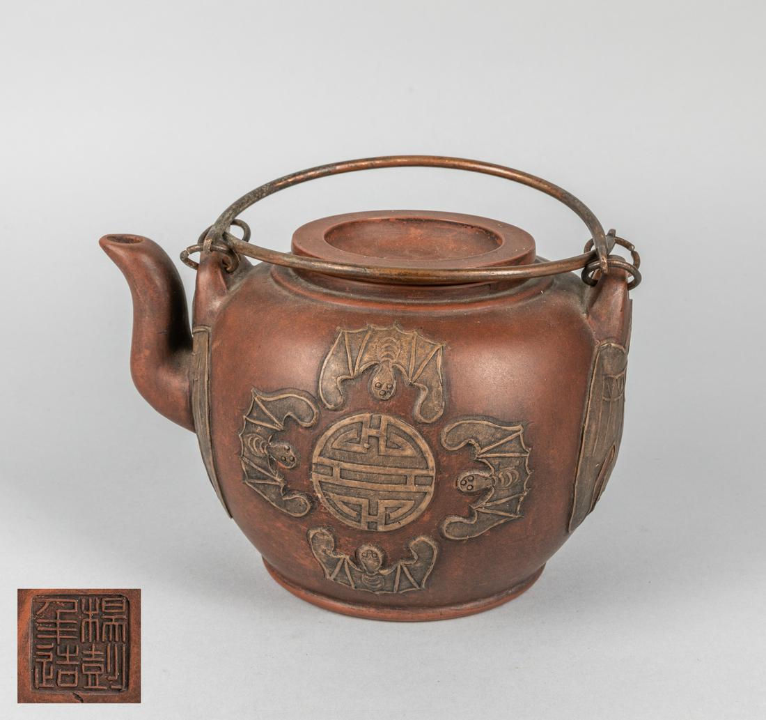 Large Chinese Zisha Tea Pot: Chinese large size Aisha teapot, decorated with bats, brass handle. 5.25 inch H; 8 inch L.