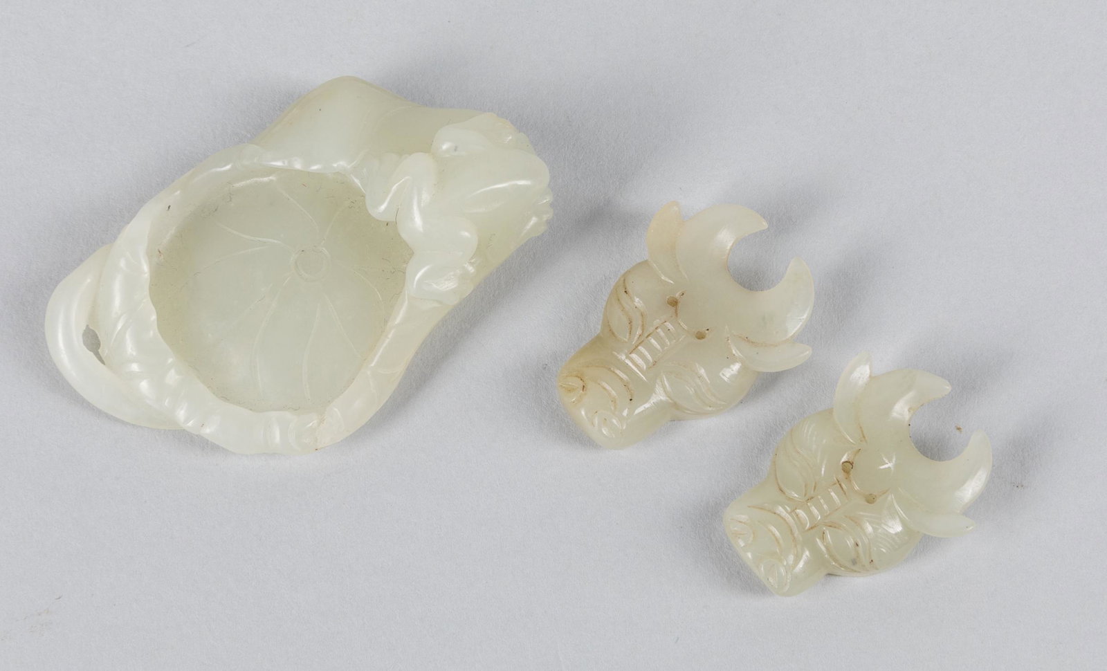 Group of Chinese White Jade Carvings: Group of three jade carving of ox heads and washer. Minor chips. 2.25 inch L; 1.3 inch W (largest).