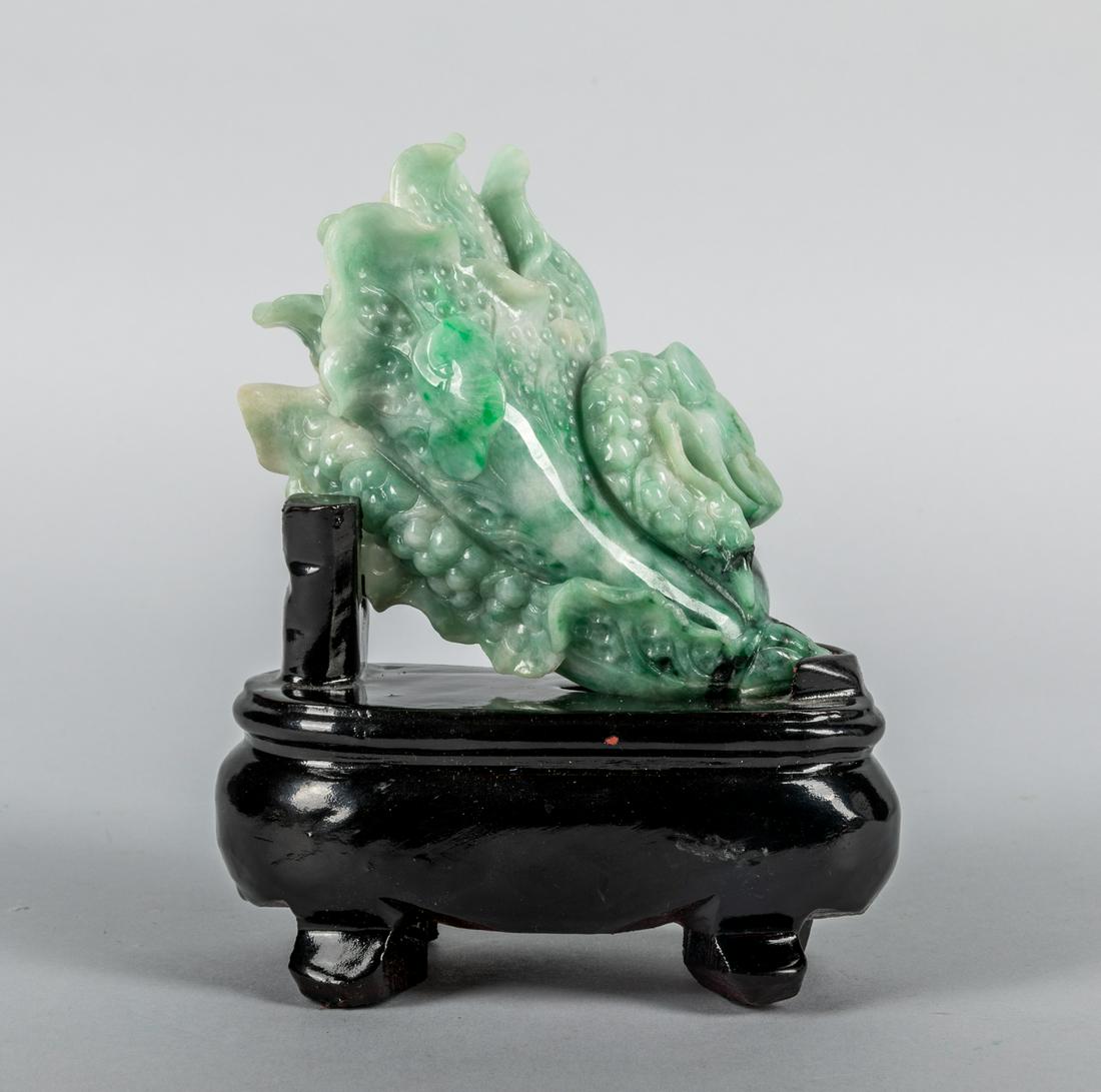 Chinese Jadeite Stone Carving: Chinese well carved jadeite carving with stand, minor crack on leaf. 5.25 inch W; 6.5 inch H with stand.