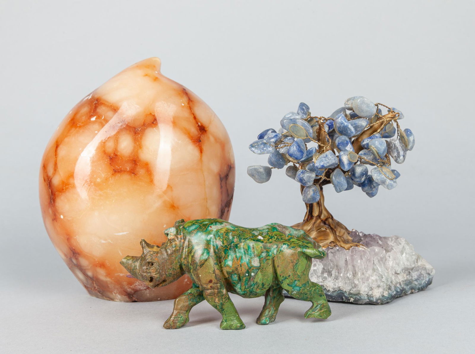 Set Chinese Export Gem Stone Figures: Set of three Chinese export gem stone figures, one carved peach, one bonsai tree, one carved rhino, the rhino horn and ear are chipped. 5x6.25 inch(largest).