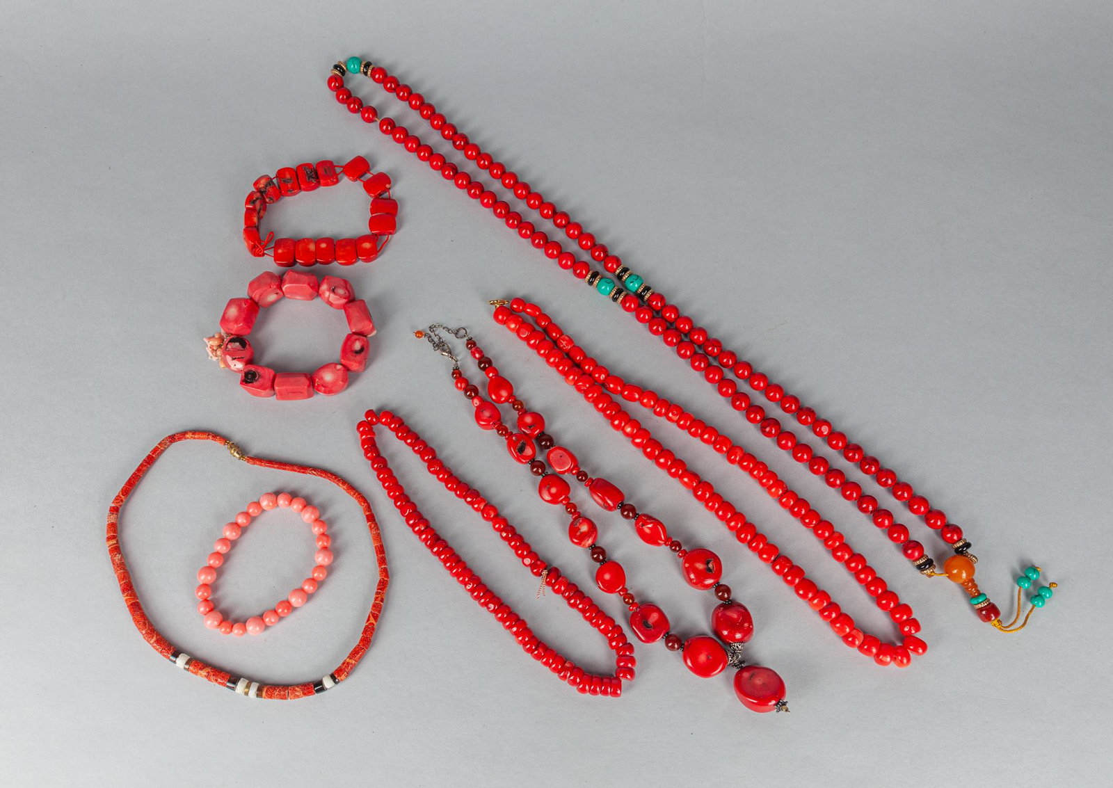 Group of Coral Like Beaded Necklaces/Bracelets: A group of eight pieces coral like beaded necklaces and bracelets. 34 inch L(largest).