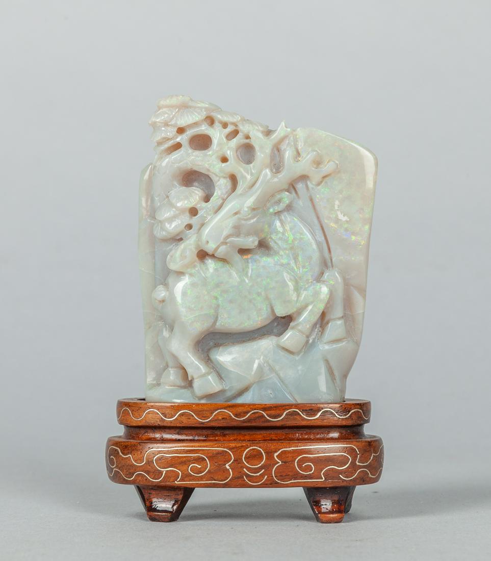 Beautiful Fire Opal Carving: Fire opal carving decorated with deer holding linchi and pine trees with stand, stone has natural crack. 3.5x2 inch(with stand). The Estate of the Cen pum Lao, Singapore.