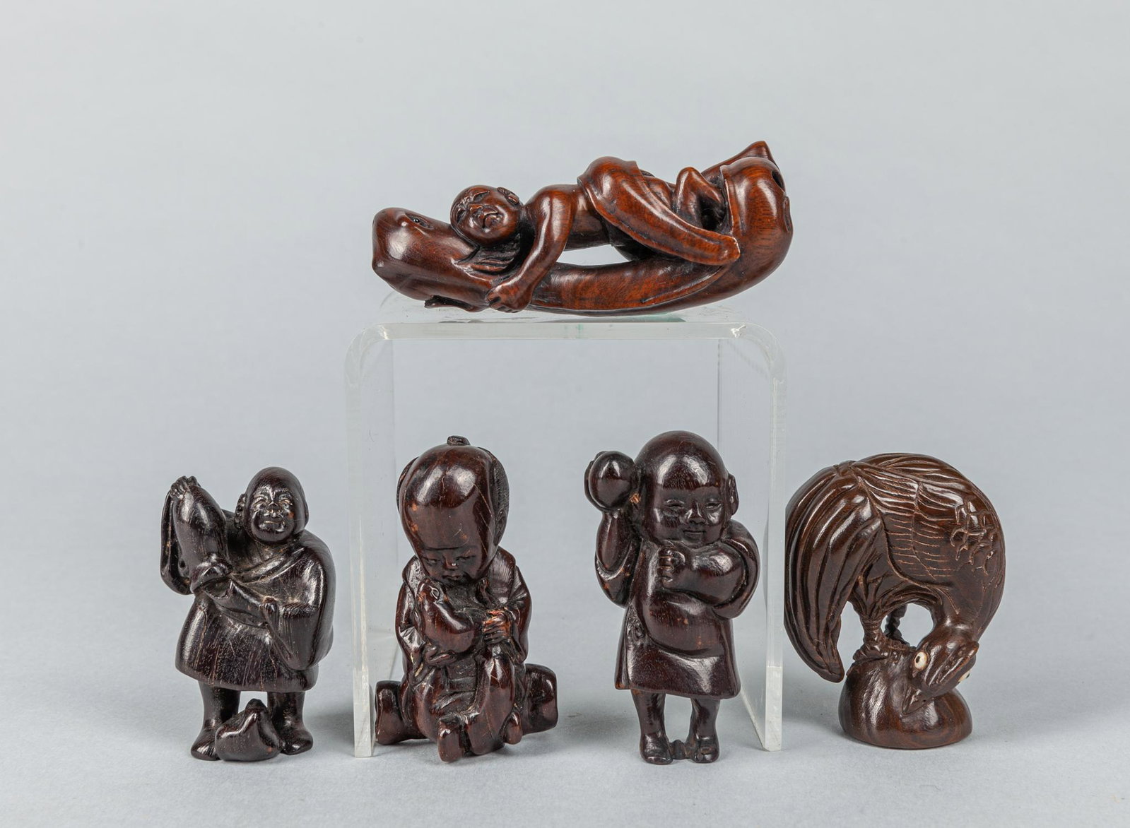 Group Japanese Wood Carved Netsukes: Group of five Japanese wood carved netsukes: three figures; one chicken; one money holding snake. 3 inch (largest); 114g (total).
