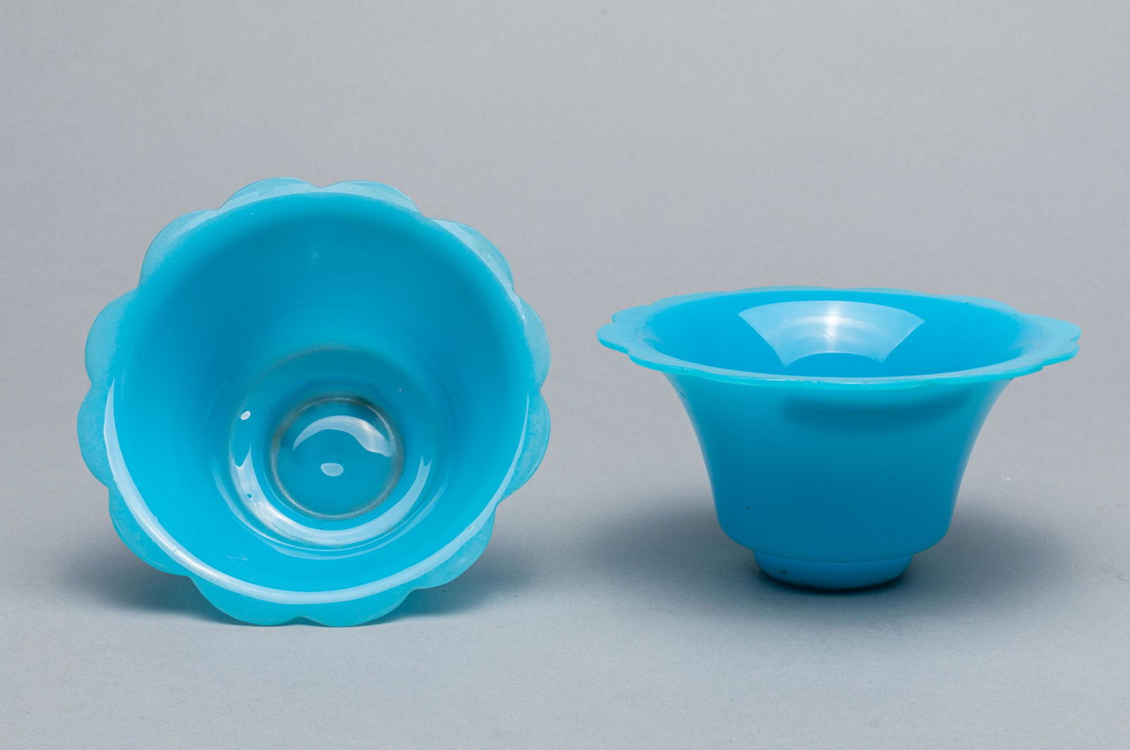 Pairs Chinese Antique Peiking Glass Lotus Cup: Pairs Chinese royal type blue glass cups, the rim carved in lobed form. 2.5 inch H; 5.1 inch D.