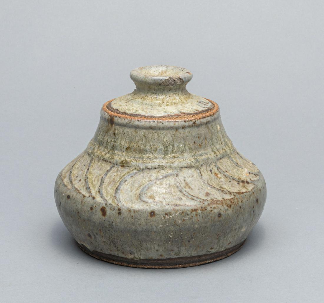 Korean Flambe Glazed Covered Jar: Collectible Korean celadon flambÃ© glazed covered Jar with archaistic pattern. 5.25inch H; 5.75 inch W.