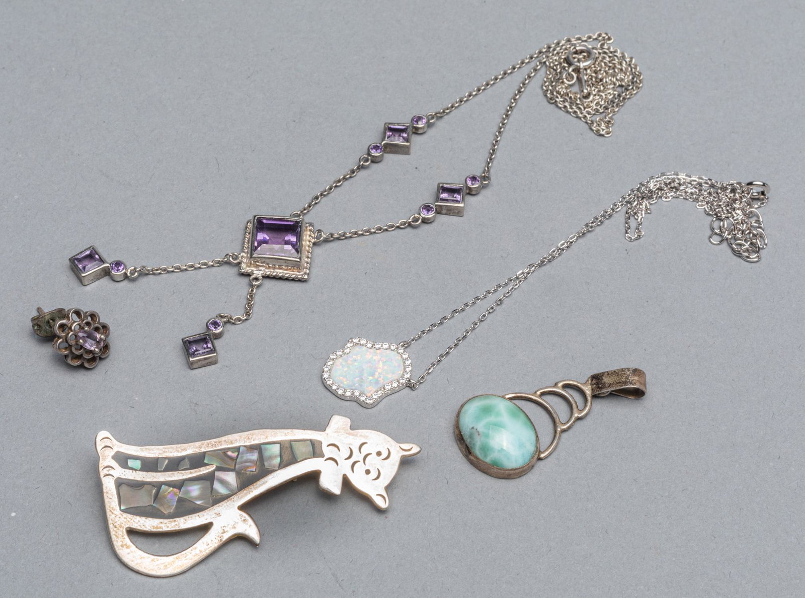 Set Sterling with Fire Opal & Gem Stone Jewelries: Set of sterling with fire opal & gem stone jewelry: one fire stone necklace; one amethyst necklace; two amethyst earning; one stone earning, one cat shape mother of pearl brooch. 20.4g W. (total weigh