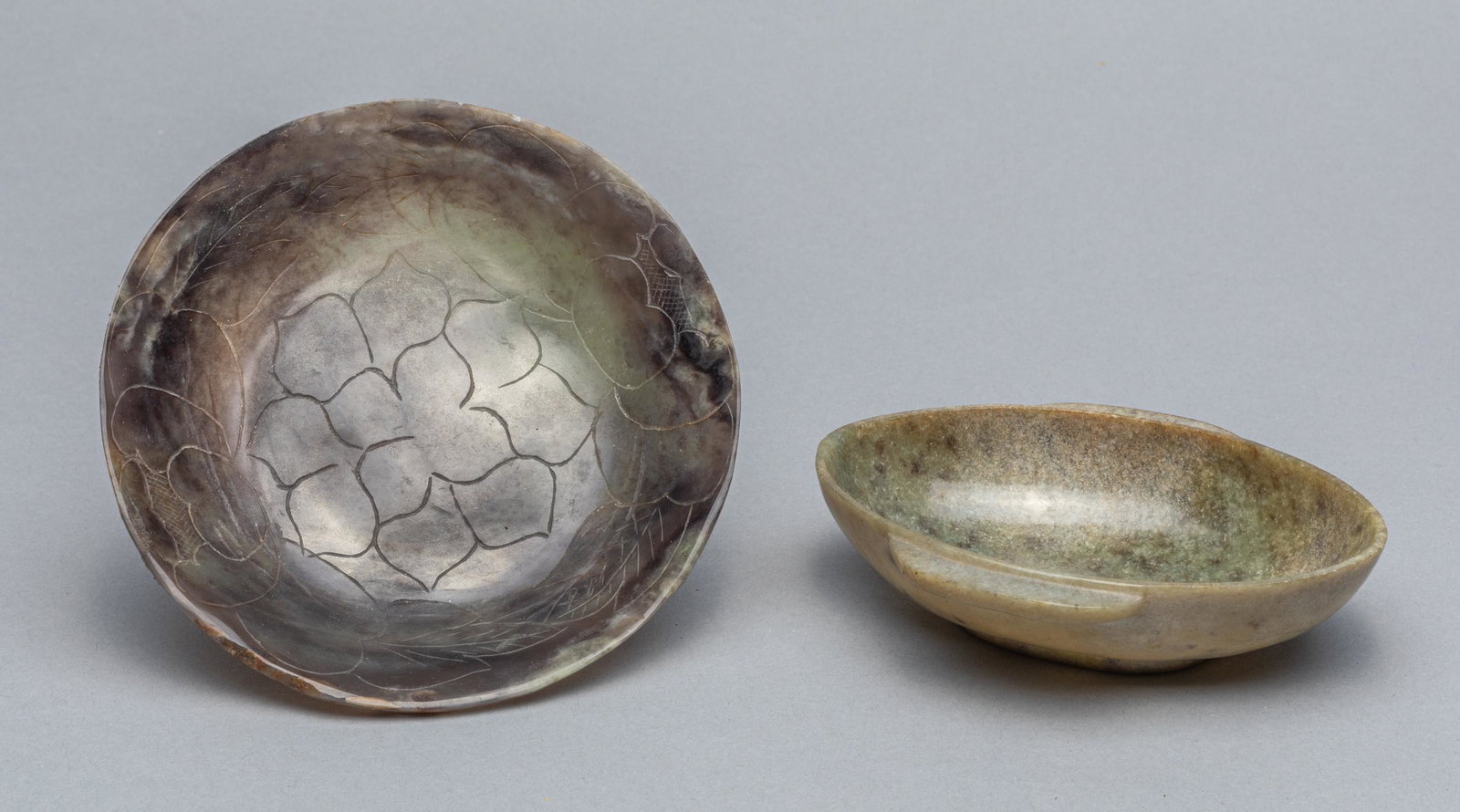 Set Chinese Jade Carving of Washer: Set of two Chinese jade carving of washers, one washer with lotus carving, chip at the rim. 5 inch D(largest).