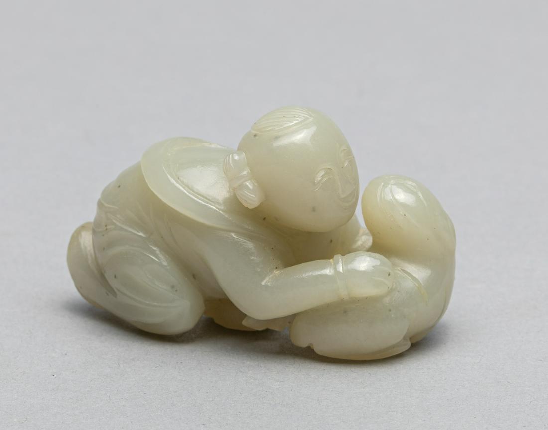 Chinese White Jade Toggle of Boy & Cat: Fine Chinese white jade toggle with carving of boy playing with cat. 3*1.6*2 inch. The Estate of the Steven Chang Art, SF, 1995.