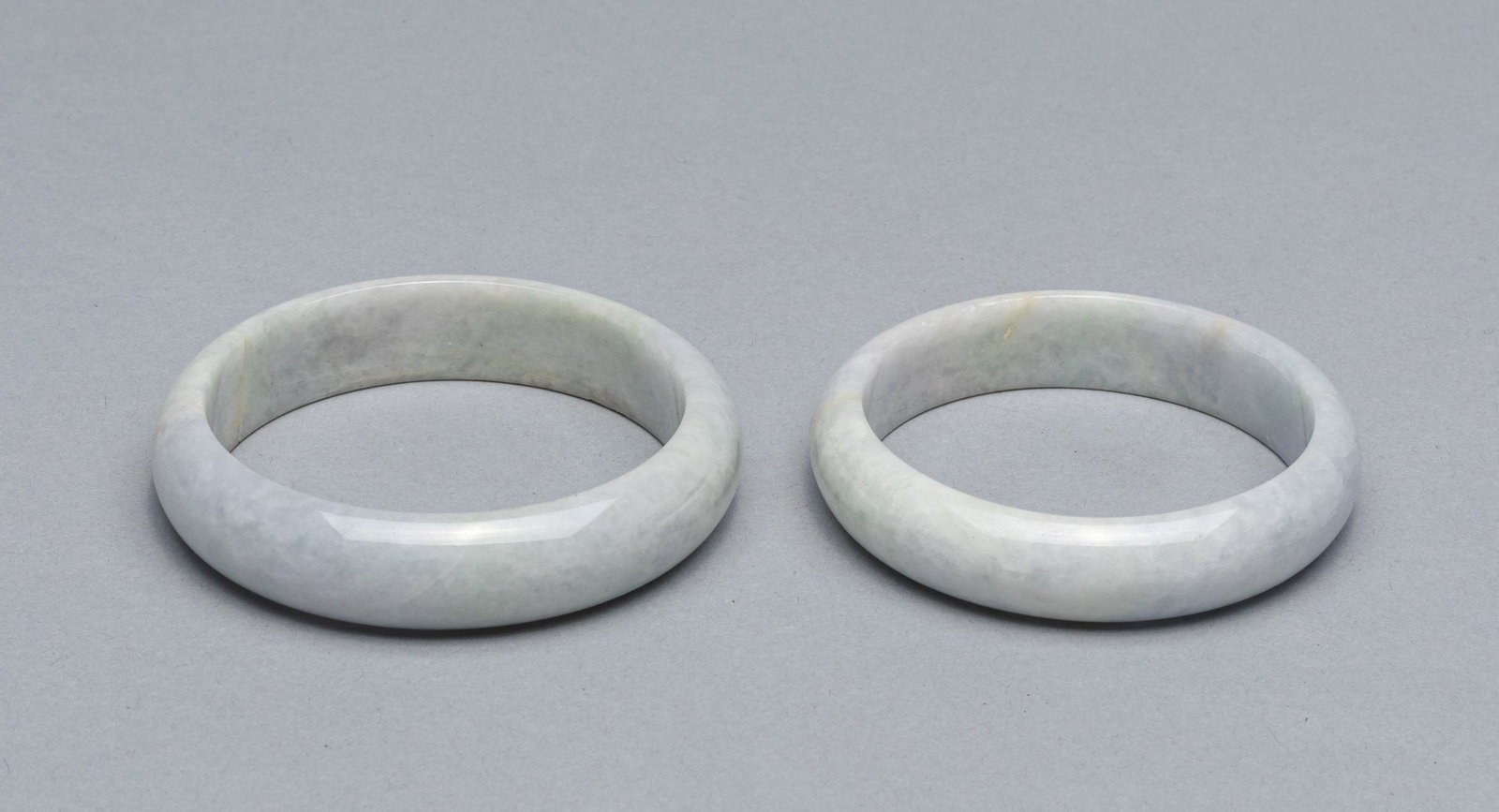 Group of Chinese Jade/Jadeite Bangles: Group of two Chinese jade/jadeite bangles, one cracked inside, one probably repaired. 3 inch(largest).