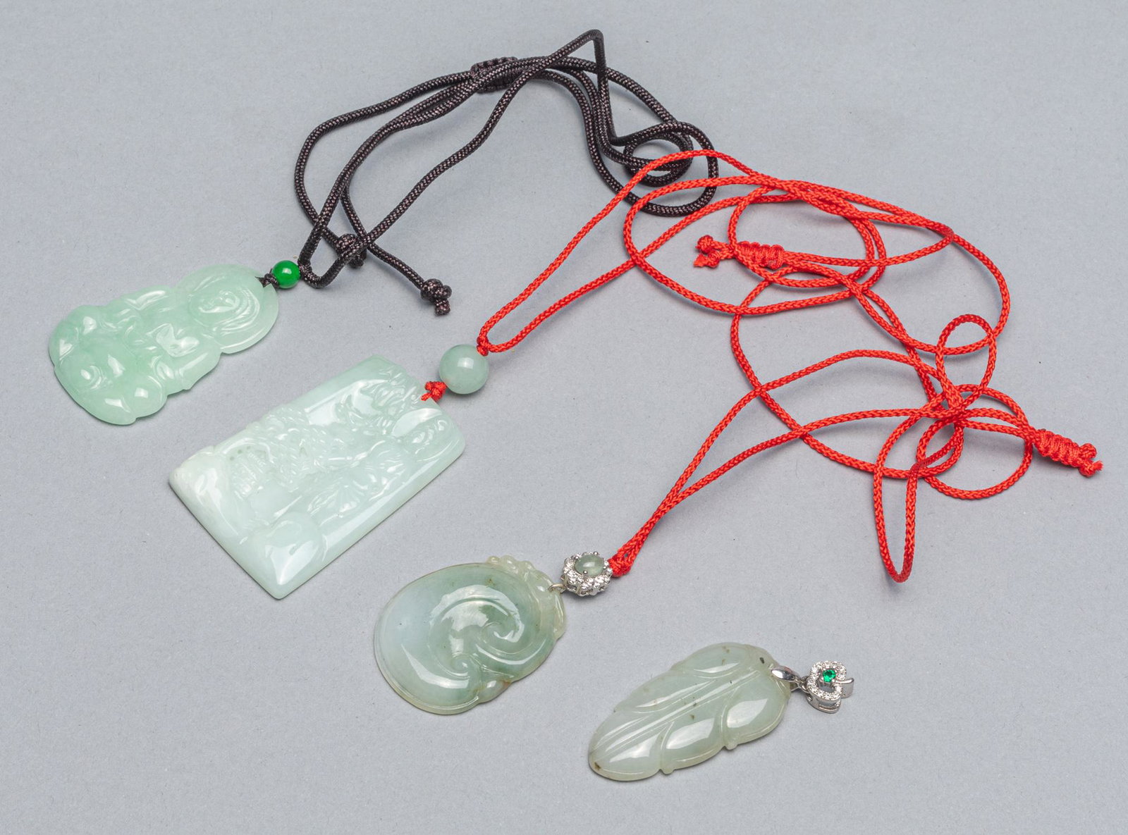 Set Chinese Jadeite Carvings: Set of four Chinese jadeite carvings of pendants. 1.4x2.1 inch(largest).