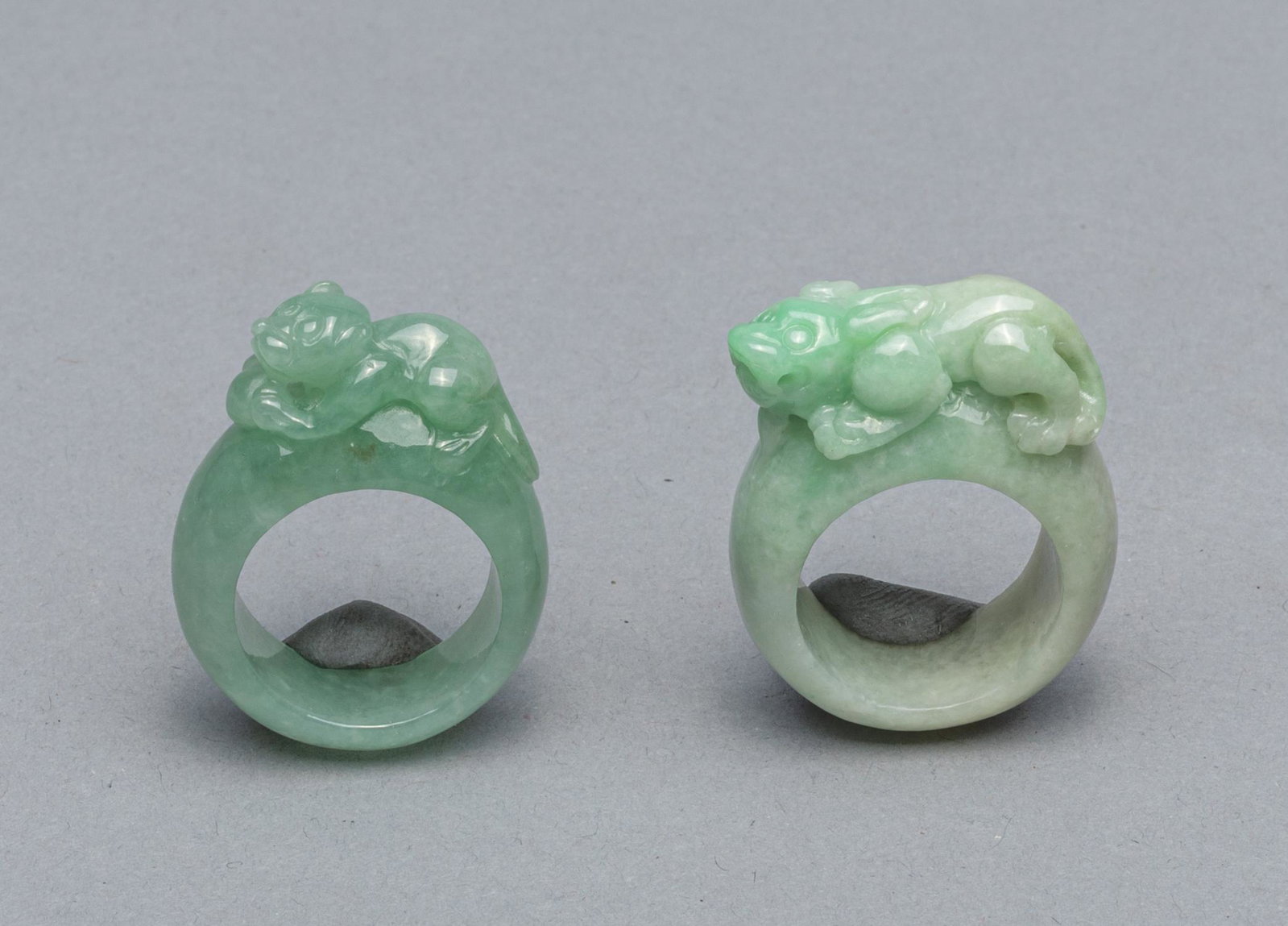 Set Jadeite Carvings of Rings: Set of two jadeite carving of rings with beast. 1.5x1.1 inch.