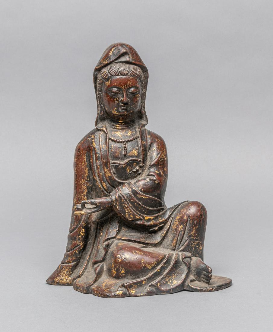 Chinese Gilt Metal Kuanyin: Chinese gilt metal kuanyin, the deity seated with the right hand rests on the edge of the base, the face with a benevolent expression detailed with downcast eyes and a benign smile. 6.75*3.9*8.5 inch.