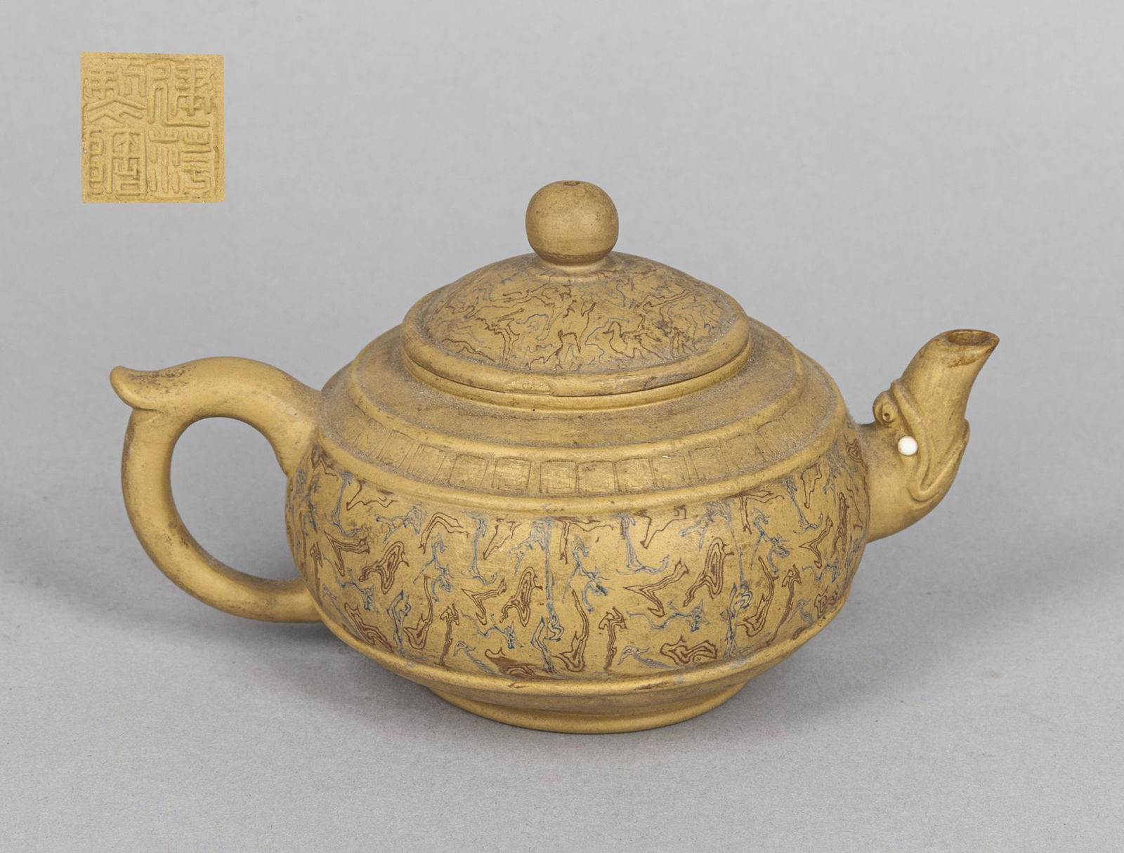 Chinese Yixing Zisha Tea Pot: The body and cover painted with wood like patterns, the spout modeled in the form of beast head, base with a seal mark. 3.8*3.4inch.