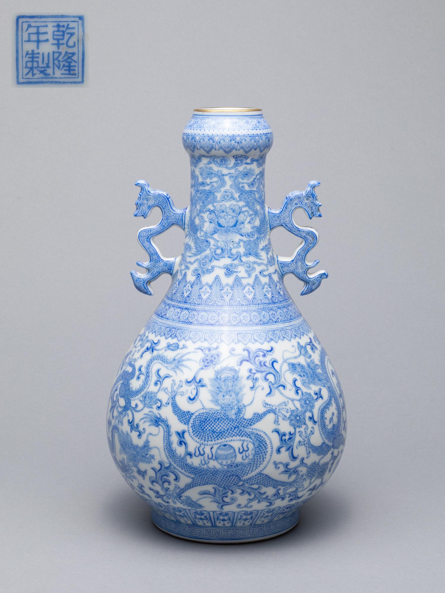 Chinese Enameled Porcelain Dragon Vase: The pear-shaped body enameled with dragons and phoenixes amidst floral and foliate scrolls, with a pair of dragon handles, base with a seal mark. 11*5.8inch.
