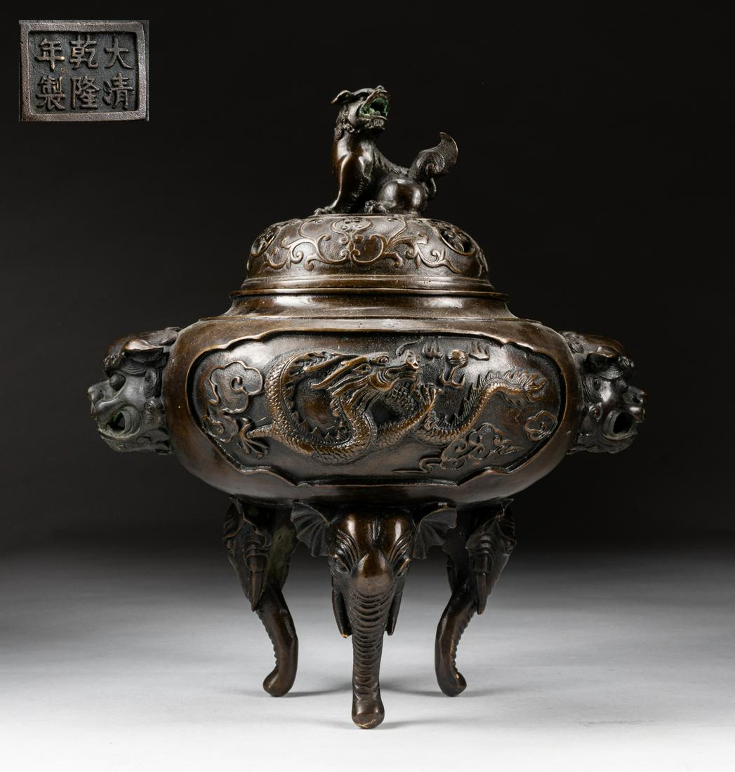 Large Japanese Meiji Bronze Dragon Incense Burner: The compressed globular body rising from three elephant head legs to a short straight neck and everted rim, finely incised around the exterior with writhing dragon panels, two with mythical beast mask