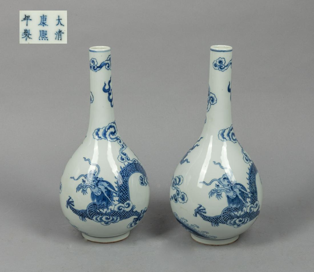 Pair Chinese Blue White Porcelain Dragon Vase: The pear-shaped body rising from a short foot to a slender neck, the exterior painted with a coiled four-clawed dragon amidst clouds and flames, and above waves, each base with a six-character mark. 1