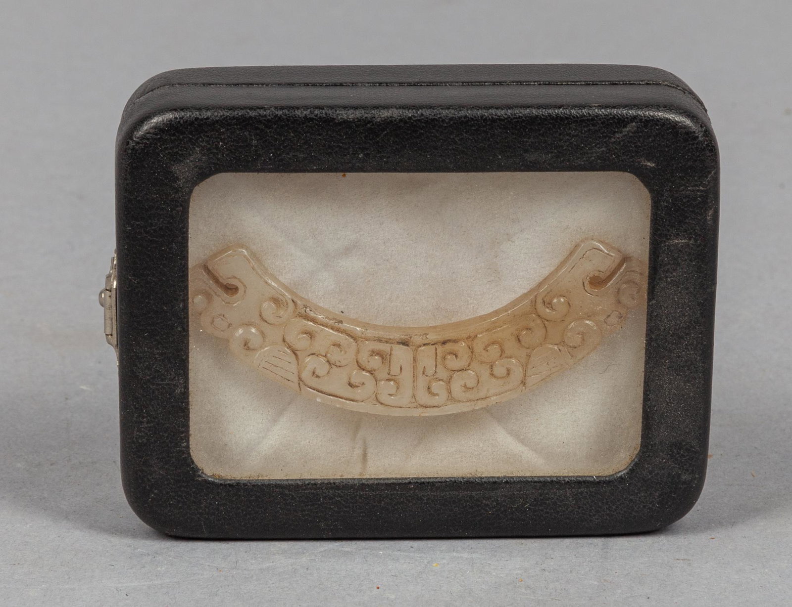 Chinese Jade Carving of Dragon: Of flat arc form with each end worked to depict a dragon's head, each flat side carved with archaic clouds motifs, the stone in white tone with russet inclusions, with box. 2.7*0.5inch.