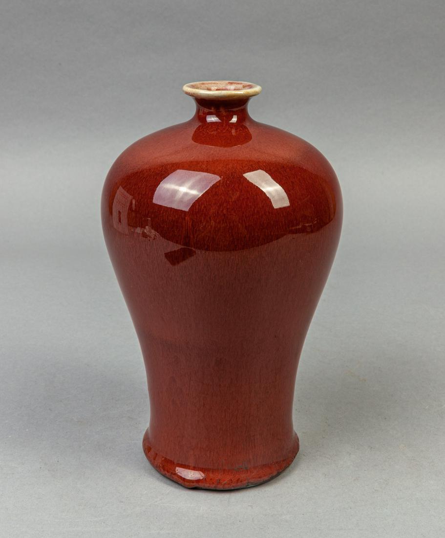 Chinese Ox-blood Red Glazed Porcelain Vase: With full rounded shoulders rising at a gently flaring angle from the base and sweeping to a short waisted neck with a lipped rim, the exterior applied with a streaked ox-blood red glaze. 8.2*4.8inch.
