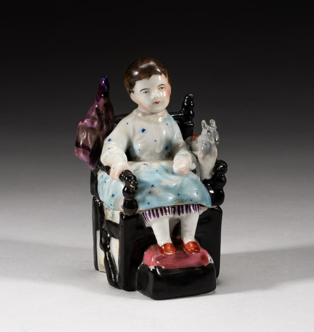 Collectible France Covered Porcelain Figure: Designed as a child sitting on an arm chair, with a doll horse on the left hand. 3.6*2.1*2inch.