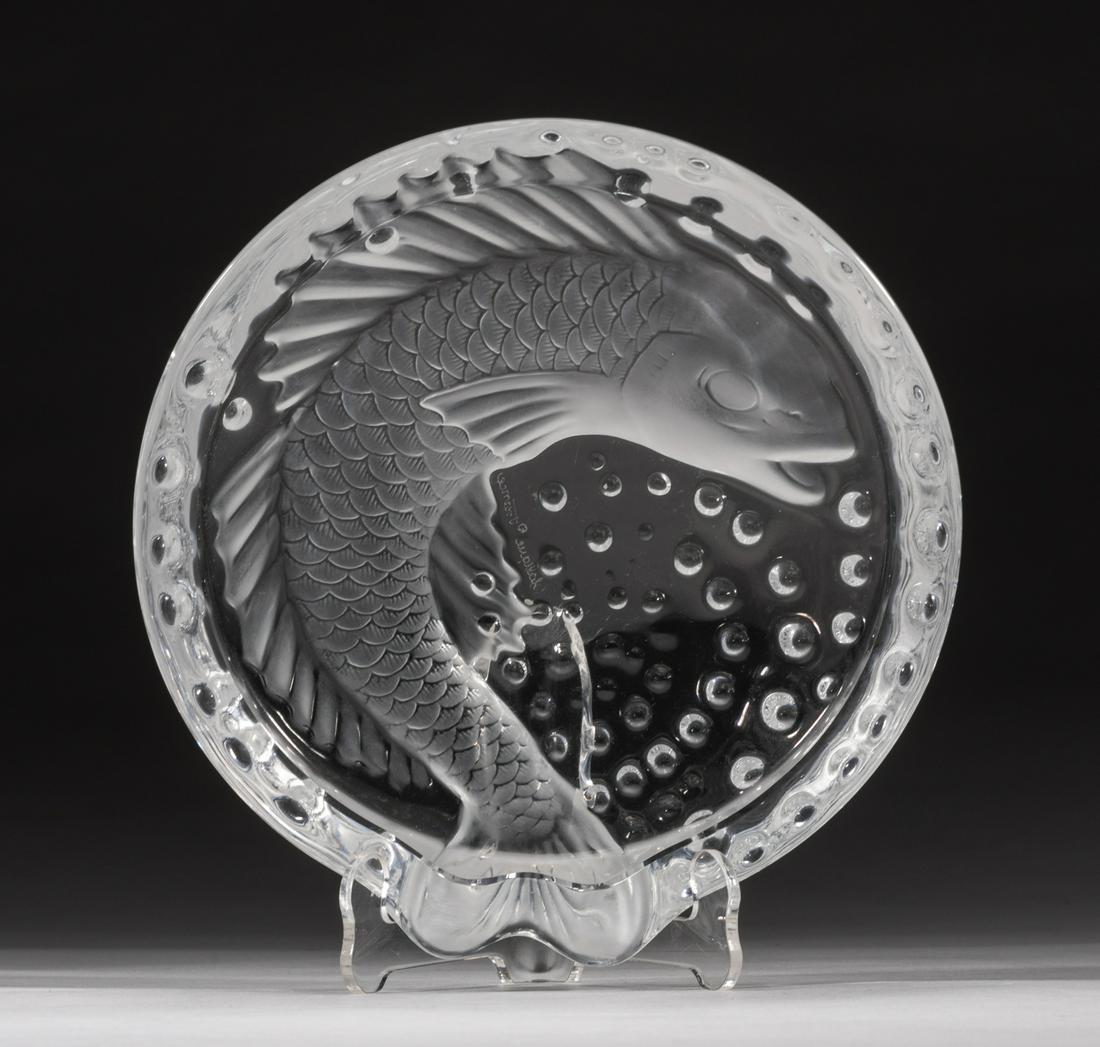 France Lalique Crystal Annual Dish Bowl: Crystal dish bowl carved with fish amidst dots to the base and marked Lalique France, fish tail stretching out the rim. 6.2*1.8inch. The Estate of the H. Lopez. Hollywood, CA, 2021.