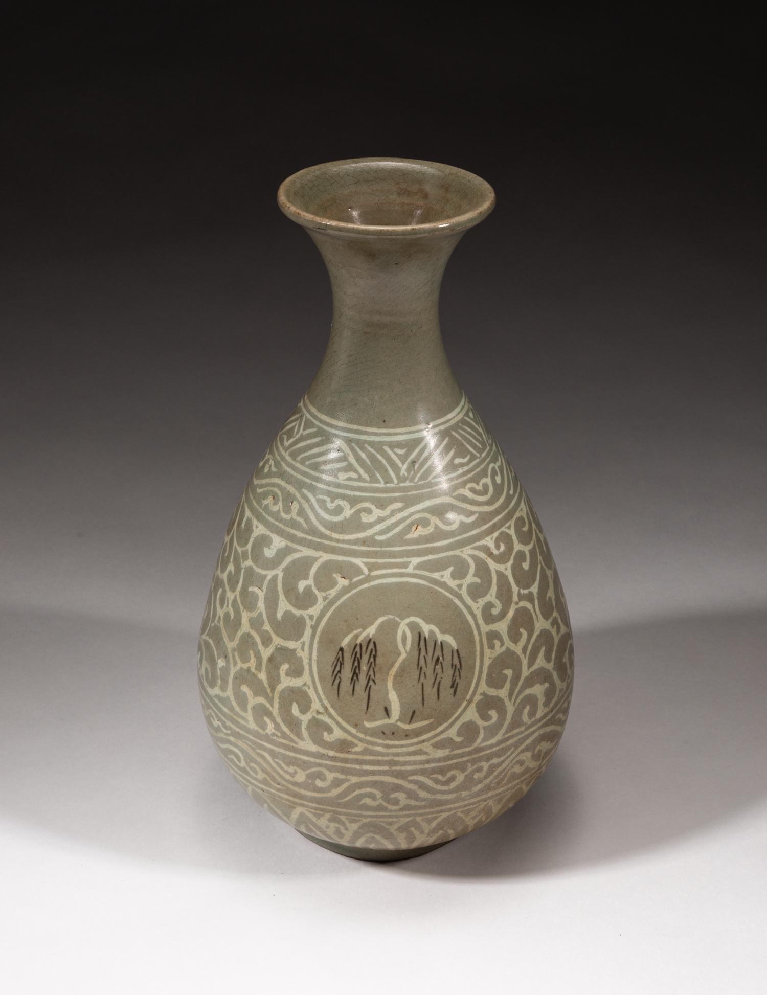 Korean Buncheong Slip-Inlaid Porcelain Vase: Overall applied with a celadon tone glaze, the pear-shaped body rising from a short foot to a waisted neck flared at the rim, painted with four medallions depicting willow trees, decorated with leafy 