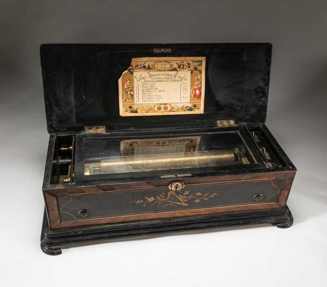 Collectible Old Swiss Interchangeable Cylinder Music: Collectible Swiss interchangeable cylinder music box, with a note and a wood box carved with flowers. Musical box is automatic musical instrument in a box that produces musical notes by using a set of