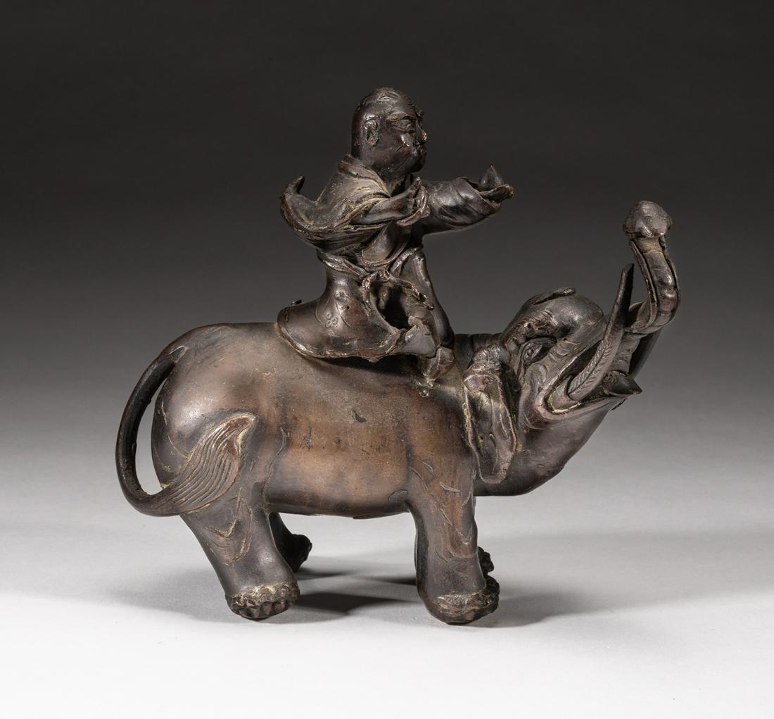 Japanese Antique Meiji Bronze Table Sculpture Luohan: Japanese Meiji type table sculpture of an elephant riding luohan, with his left hand holding a peach and right hand holding a ring, the elephant head looking upward. 8*7.2*2.7inch. The Estate of the H