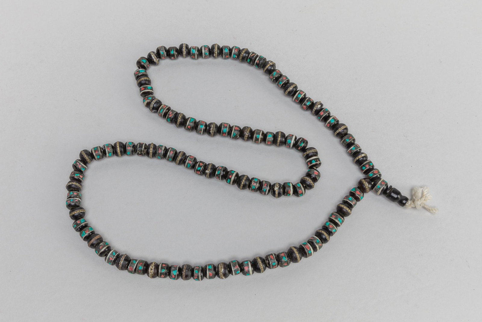 Collectible Tibetan Old Bone Necklace Inlaid Gem Stone: Antique Tibetan type old black color bone bead necklace inlaid with turquoise and coral like stone. 27inch L.