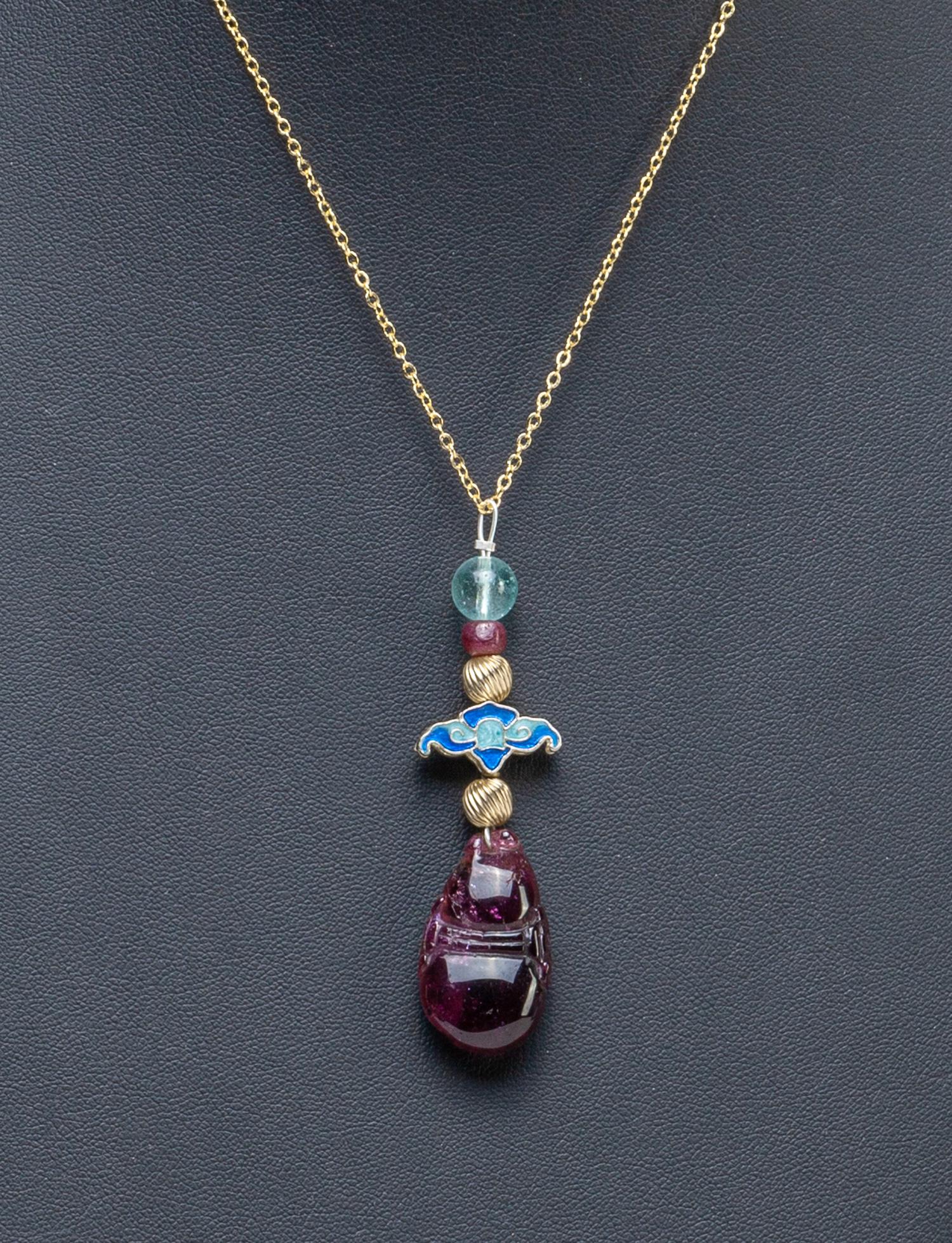 Chinese Wine Red Tourmaline Necklace: Tourmaline toggle carved in gourd form, with an enameled bat and an aquamarine bead, with a chain necklace marked 18KGP. 1.1*0.65*0.3inch (tourmaline only).