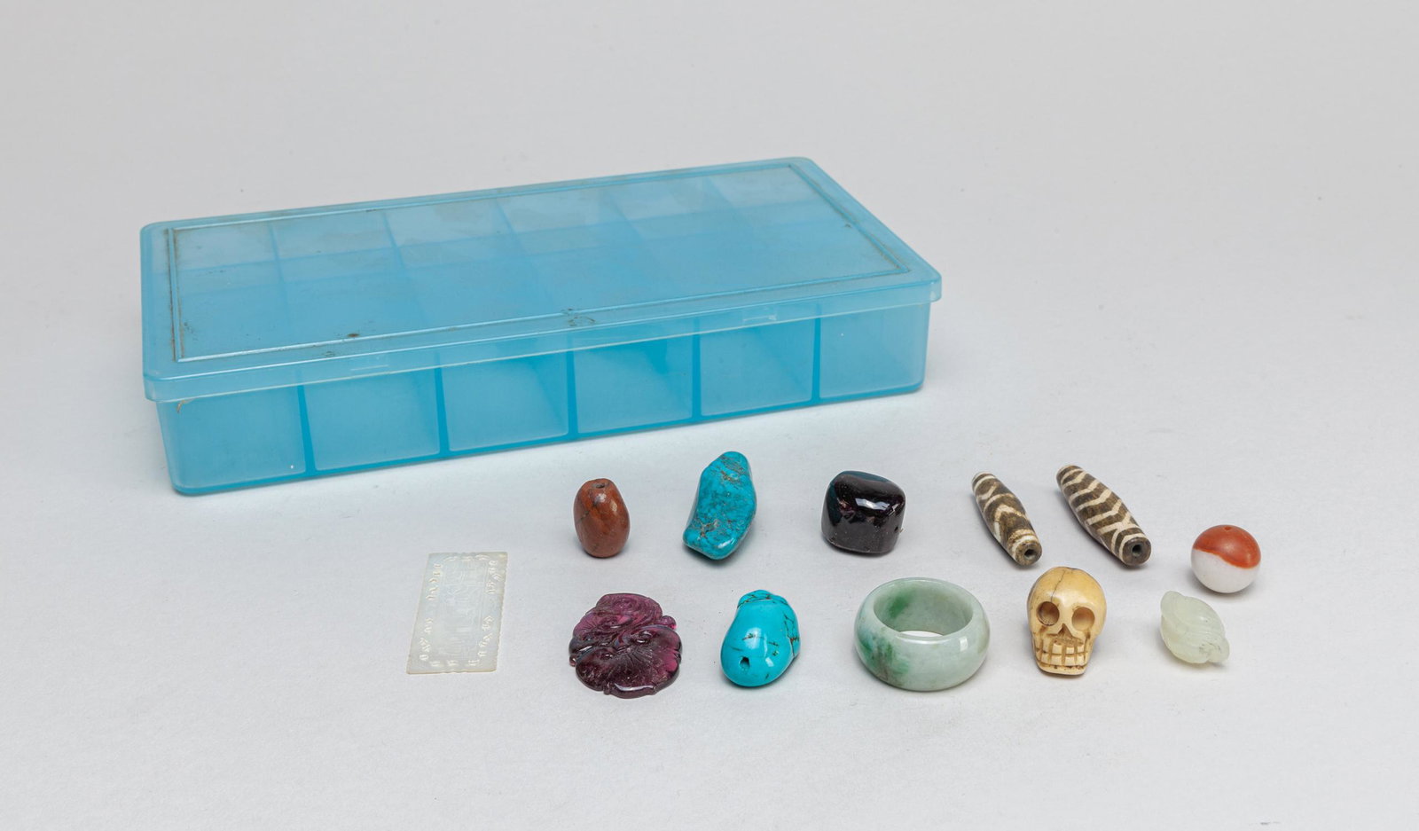 Collectible Chinese Jade, Tourmaline Carvings: A mix group of beads and carvings, composed of agate, bone, tourmaline, agate, jade, turquoise, mother of pear and gemstone, with a blue organized box. 1.6*0.7*0.5inch (largest).